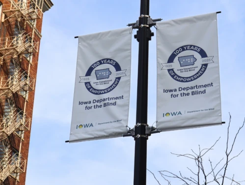 Iowa Department for the Blind banners hanging on a street post 