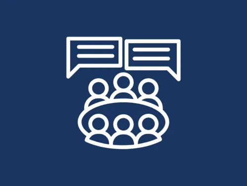 Icon of six people around a table with two speech bubbles above them.