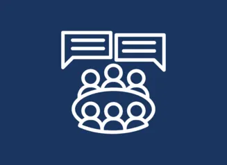 Icon of six people around a table with two speech bubbles above them.