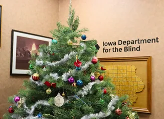Decorated Holiday tree inside the Iowa Department for the Blind office.